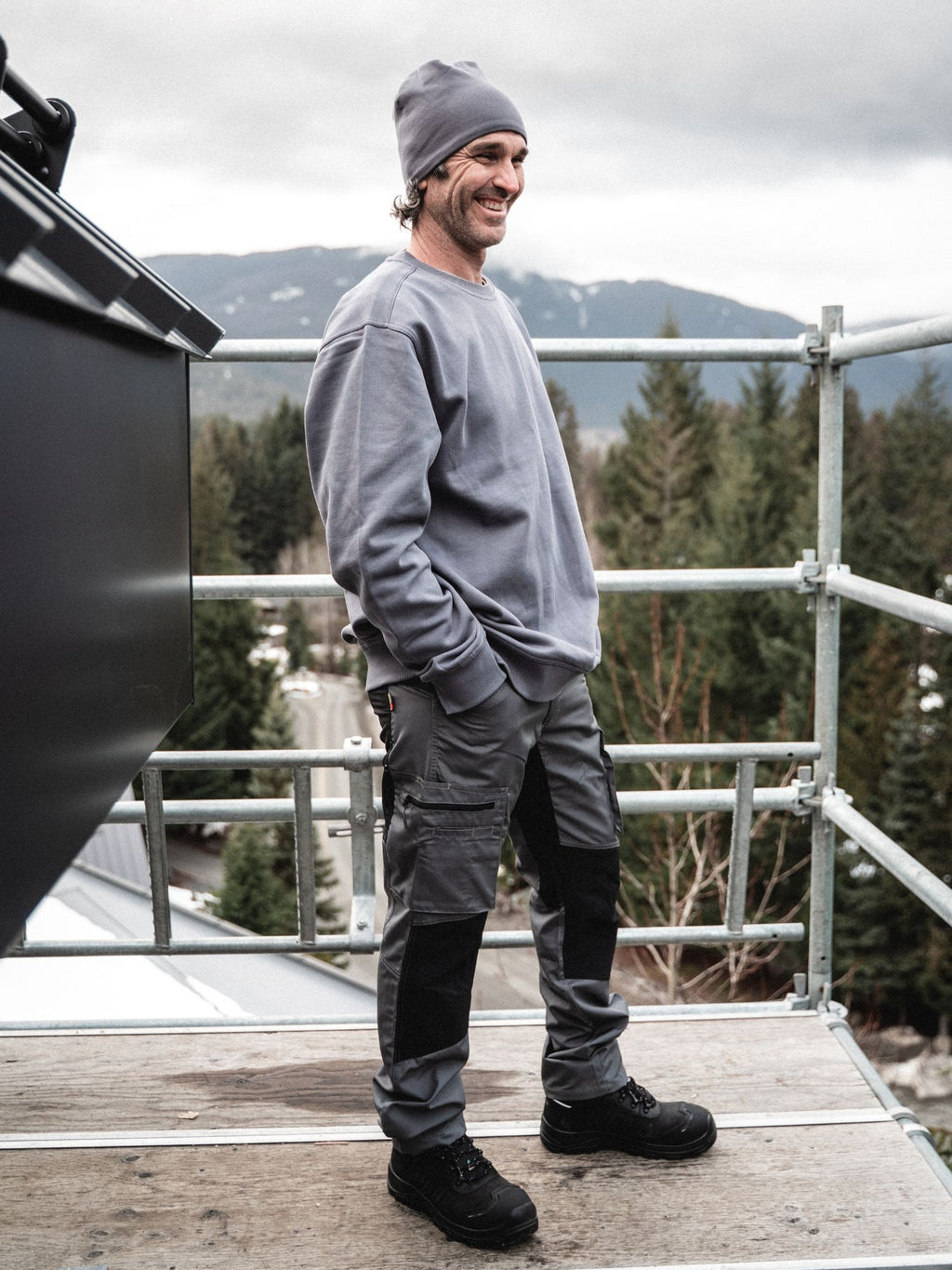 Tradesman on construction site wearing Blaklader Service Pants with Stretch in grey