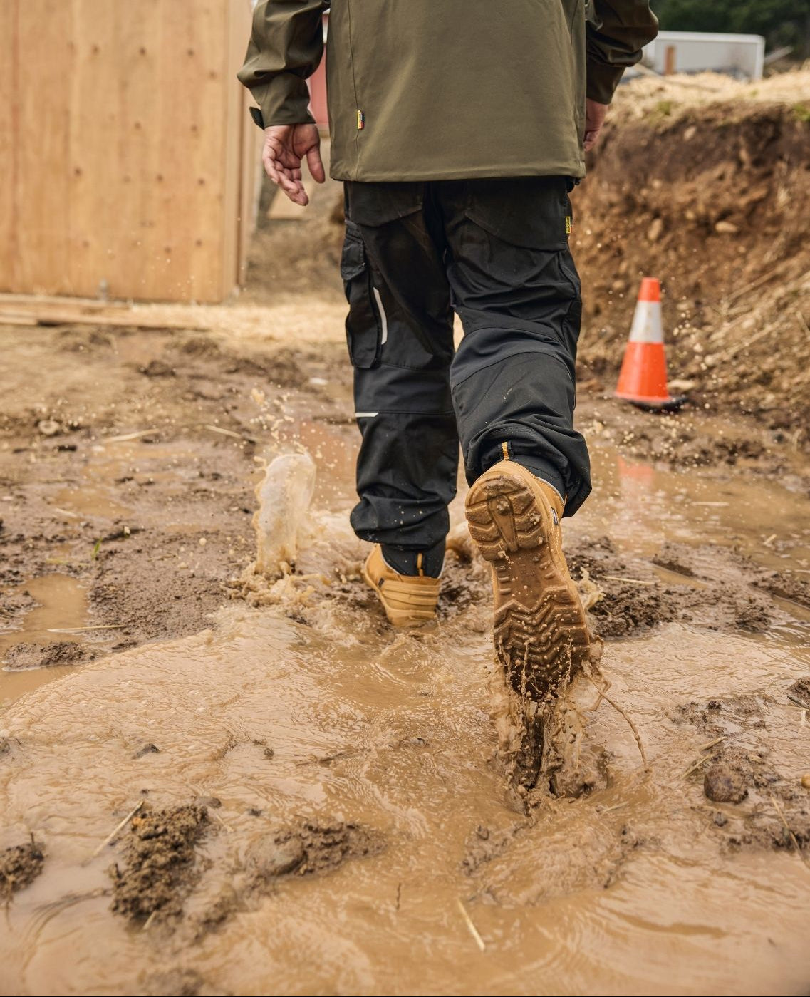 Blaklader Elite 6 Inch Freelock Safety Boots in Wheat walking through muddy construction site