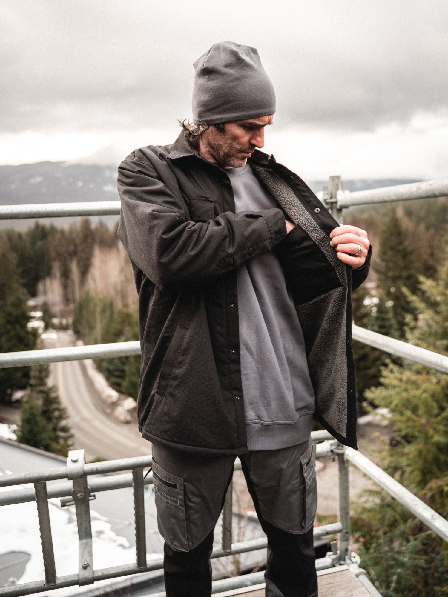 Construction worker on jobsite wearing Blaklader Ripstop Jacket in Black