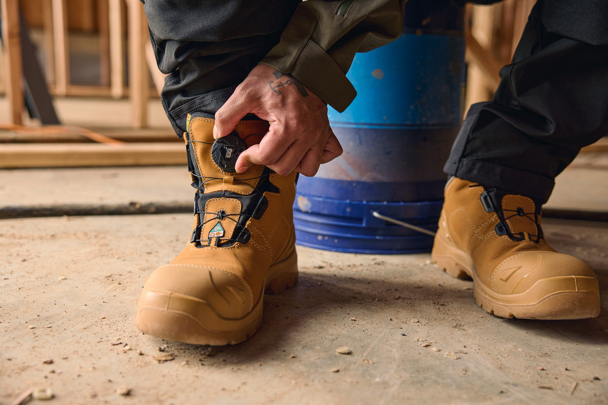 Tradesperson wearing 6" Elite Freelock Safety Boots in wheat