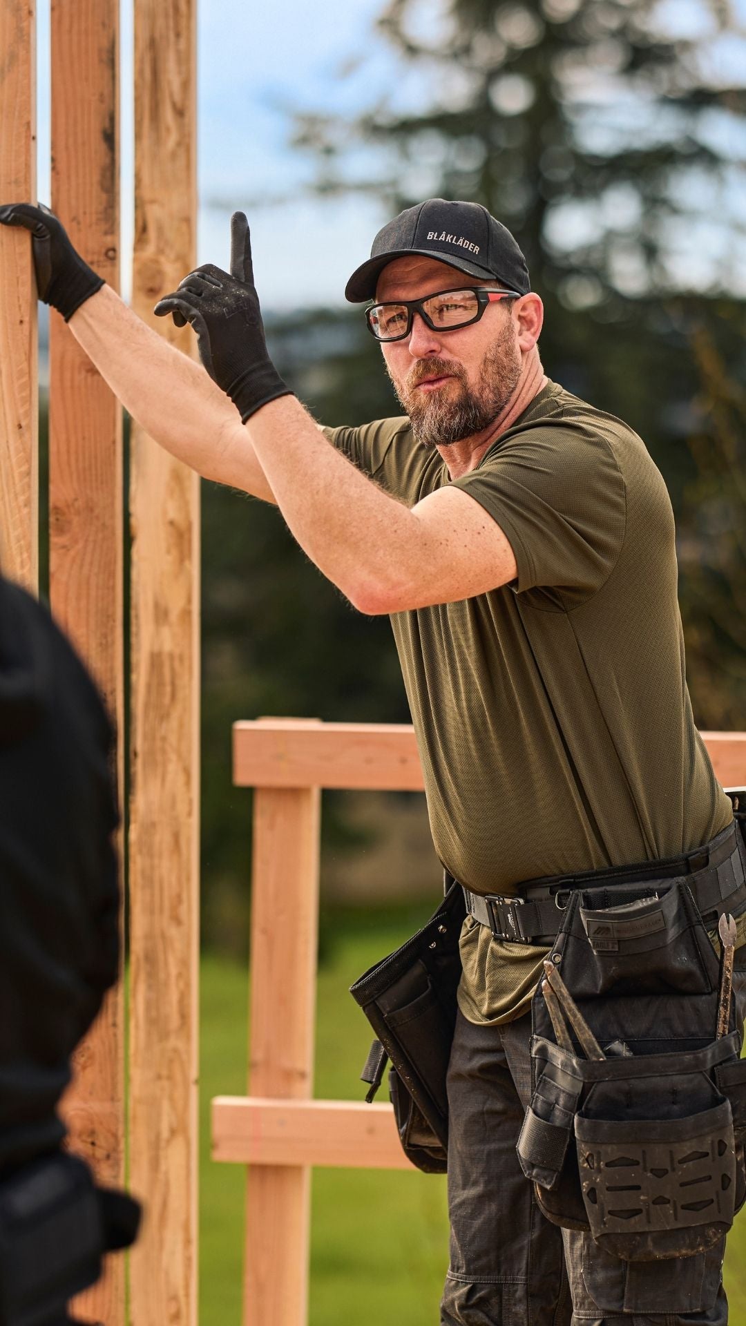 Tradesman working on construction site in premium sun protection workwear