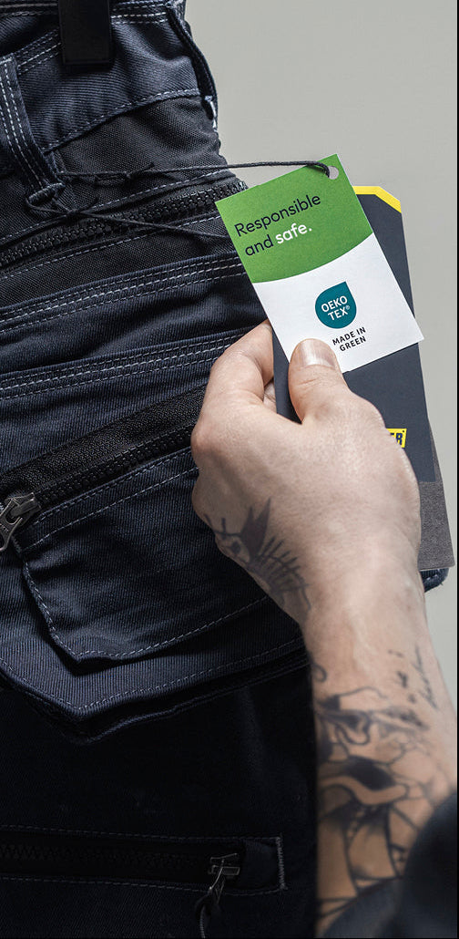 Person holding a smartphone with a screen displaying a product image, wearing dark jeans.