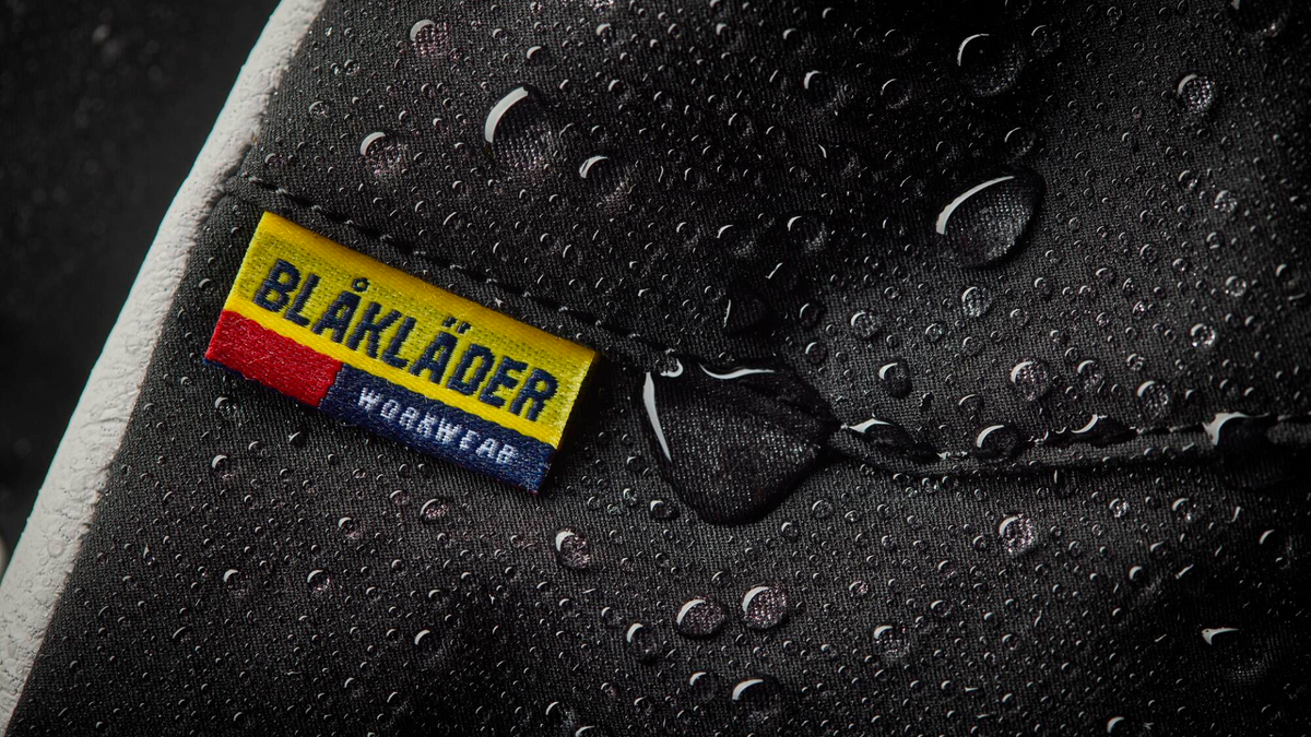 Bläkläder workwear label on a rain-soaked surface